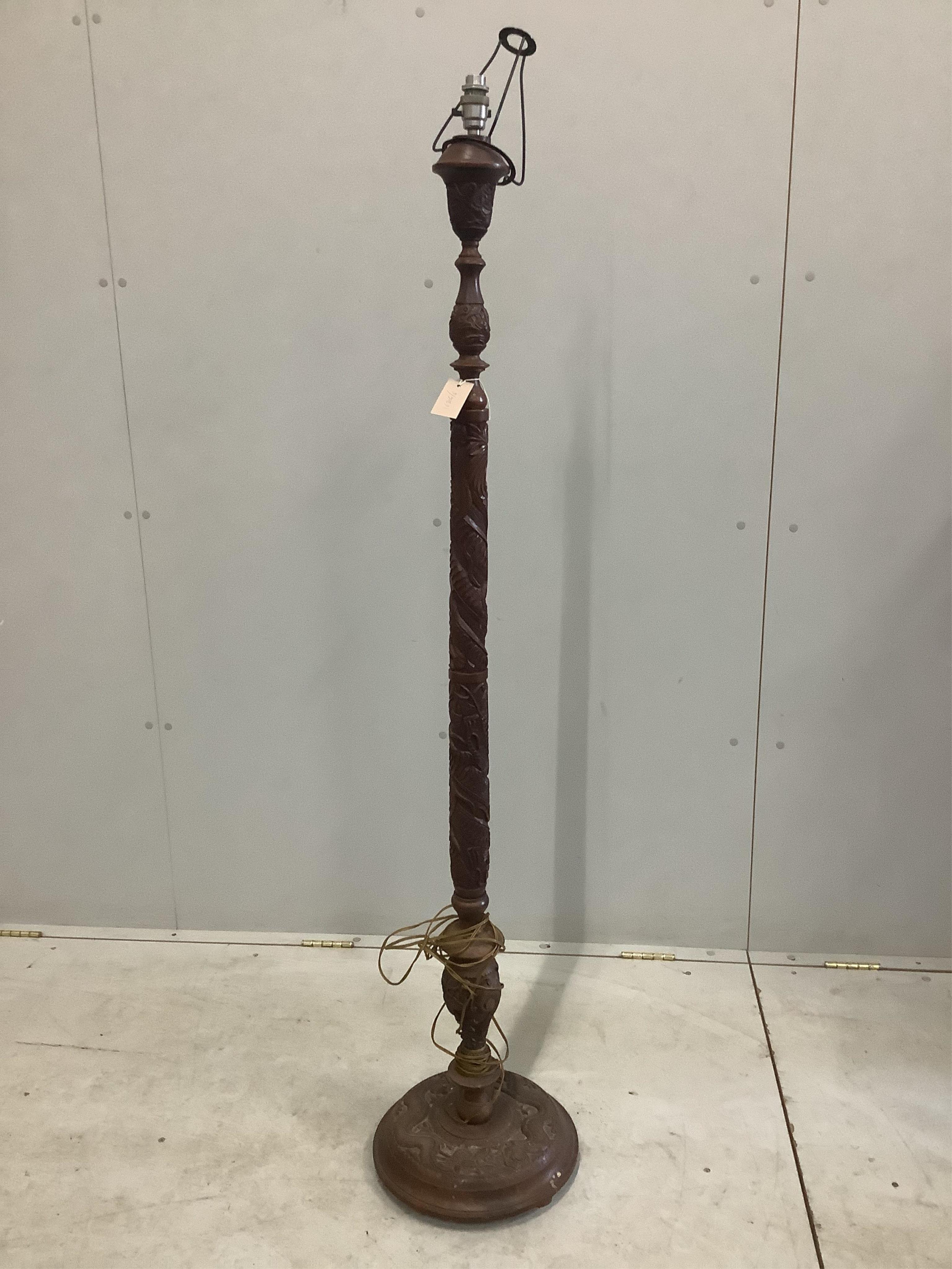 A 19th century Asian hardwood lamp standard carved with dragons, height 150cm, together with a carved mahogany torchere, height 100cm. Condition - fair